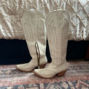 White knee-high Ariat cowgirl boots